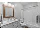 Well-lit bathroom with a vanity, marble countertop, and bathtub at 7845 Village Harbor Dr, Cornelius, NC 28031