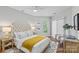 Well-lit bedroom with neutral tones, tufted headboard, and modern decor at 7845 Village Harbor Dr, Cornelius, NC 28031