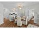 Charming dining area adjacent to the kitchen, featuring a stylish chandelier and comfortable seating for four at 7845 Village Harbor Dr, Cornelius, NC 28031