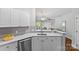 Modern kitchen featuring white cabinets, gray subway tile backsplash, and quartz countertops with stainless steel appliances at 7845 Village Harbor Dr, Cornelius, NC 28031