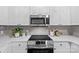 Contemporary kitchen with stainless steel appliances, subway tile backsplash, and white cabinets for a clean, modern look at 7845 Village Harbor Dr, Cornelius, NC 28031
