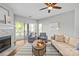 Bright living room with hardwood floors, ceiling fan, and a cozy seating area with modern decor at 7845 Village Harbor Dr, Cornelius, NC 28031