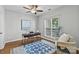 Cozy home office featuring a modern desk, stylish blue rug, and a comfortable chair by the window at 7845 Village Harbor Dr, Cornelius, NC 28031