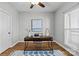 Bright home office space with a contemporary desk, decor, and hardwood floors at 7845 Village Harbor Dr, Cornelius, NC 28031