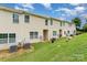 A view of the back of a home, showing a spacious green lawn at 8953 Bradstreet Commons Way, Charlotte, NC 28215