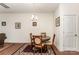 Bright dining room includes a wood table, four chairs, and decorative wall art at 8953 Bradstreet Commons Way, Charlotte, NC 28215