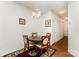 Bright dining room features a wood table, four chairs, and decorative wall art at 8953 Bradstreet Commons Way, Charlotte, NC 28215