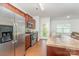 Well-lit kitchen features stainless steel appliances, wood floors, and a convenient exterior door at 8953 Bradstreet Commons Way, Charlotte, NC 28215
