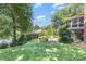Well-manicured backyard with lush landscaping, a fire pit area, and a glimpse of the patio at 905 Mangionne Dr, Matthews, NC 28105
