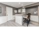 Basement bar area features white cabinetry, mosaic backsplash, and seating for entertaining at 905 Mangionne Dr, Matthews, NC 28105