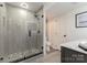 Modern bathroom featuring a glass shower, vanity with marble countertop, and gray tile at 905 Mangionne Dr, Matthews, NC 28105