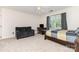 Bedroom with neutral carpet, a couch, a bed with a quilt, and a window with gray curtains at 905 Mangionne Dr, Matthews, NC 28105