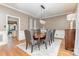 Formal dining room features a chandelier, hardwood floors, and a neutral color palette at 905 Mangionne Dr, Matthews, NC 28105