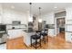 Spacious kitchen with white cabinets, granite countertops, stainless steel appliances, and a central island at 905 Mangionne Dr, Matthews, NC 28105