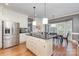 Spacious kitchen with white cabinets, stainless steel refrigerator, and an island with pendant lighting at 905 Mangionne Dr, Matthews, NC 28105