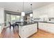 Bright eat-in kitchen featuring a black island, white cabinetry, and stainless appliances at 905 Mangionne Dr, Matthews, NC 28105