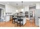 Modern kitchen with white cabinets, black countertops, stainless steel appliances, and an island at 905 Mangionne Dr, Matthews, NC 28105