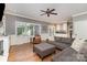 Comfortable living room featuring a grey sofa, leather chair, and hardwood floors at 905 Mangionne Dr, Matthews, NC 28105