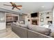 Inviting living room featuring a brick fireplace, built-in shelving, and an adjacent game room at 905 Mangionne Dr, Matthews, NC 28105