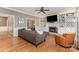Elegant living room features a cozy fireplace, built-in bookshelves, and hardwood floors at 905 Mangionne Dr, Matthews, NC 28105