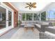 Screened-in patio with wicker seating, ceiling fan, and view of the backyard at 905 Mangionne Dr, Matthews, NC 28105