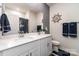 Bathroom with double sinks, a large mirror, a nautical themed decor, and modern fixtures at 9274 Dunwich Dr, Gastonia, NC 28056