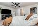 Comfortable bedroom with ample lighting, a ceiling fan, and a television, perfect for relaxing and unwinding at 9274 Dunwich Dr, Gastonia, NC 28056