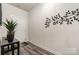 Bright entryway featuring wood-look flooring, decorative wall art, and a console table with greenery at 9274 Dunwich Dr, Gastonia, NC 28056