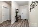 Modern entryway with wood-look flooring, stylish console table, and decorative wall art at 9274 Dunwich Dr, Gastonia, NC 28056