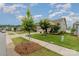 Landscaped front yard with young trees bordering the sidewalk enhances this lovely home's curb appeal at 9274 Dunwich Dr, Gastonia, NC 28056