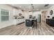 Bright, open kitchen with white cabinetry, stainless steel appliances, and a center island with bar stools at 9274 Dunwich Dr, Gastonia, NC 28056
