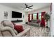 Inviting living room featuring a cozy rug, comfortable seating, and modern lighting fixtures at 9274 Dunwich Dr, Gastonia, NC 28056