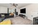 Inviting living room with a comfortable sofa, TV, and a ceiling fan, ideal for relaxation and entertainment at 9274 Dunwich Dr, Gastonia, NC 28056