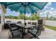 Outdoor patio features a dining set with umbrella, hot tub, and white fence, perfect for entertaining at 9274 Dunwich Dr, Gastonia, NC 28056