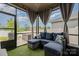 Screened-in porch featuring comfortable wicker furniture with plush cushions overlooking the backyard at 9274 Dunwich Dr, Gastonia, NC 28056