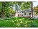 Expansive backyard with lush green grass, mature trees, and a well-maintained lawn at 928 Tally Ho Ct, Charlotte, NC 28212