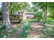 Picturesque backyard featuring a wooden deck, green lawn, and lots of trees at 928 Tally Ho Ct, Charlotte, NC 28212
