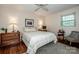 Cozy bedroom featuring hardwood floors, neutral paint, and natural light from a window at 928 Tally Ho Ct, Charlotte, NC 28212