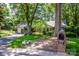 Charming single-story brick home featuring mature trees, lush landscaping, and a welcoming front lawn at 928 Tally Ho Ct, Charlotte, NC 28212