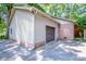 Side view of a single-car garage attached to the house with a concrete driveway at 928 Tally Ho Ct, Charlotte, NC 28212