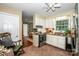 Well-lit kitchen featuring white cabinetry, tile flooring, and a view into the adjoining dining area at 928 Tally Ho Ct, Charlotte, NC 28212