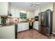 Bright kitchen with tile flooring, white cabinets, stainless steel appliances, and natural light at 928 Tally Ho Ct, Charlotte, NC 28212