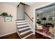 Classic stairway with wooden steps, white risers, and access to the home's living room at 928 Tally Ho Ct, Charlotte, NC 28212