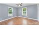 Bright bedroom with two windows letting in natural light and hardwood flooring at 952 Salisbury St, Wadesboro, NC 28170
