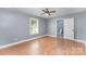 This bedroom features a ceiling fan, wood-look flooring, and an adjacent bathroom at 952 Salisbury St, Wadesboro, NC 28170
