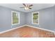 Bright bedroom with two windows letting in natural light and hardwood flooring at 952 Salisbury St, Wadesboro, NC 28170