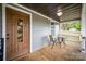 Relaxing front porch with wood floors and a comfortable seating area at 952 Salisbury St, Wadesboro, NC 28170