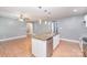 Bright and open kitchen with island, stainless steel appliances and laminate floors at 952 Salisbury St, Wadesboro, NC 28170