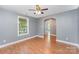 This living room boasts hardwood floors, neutral paint and open archway at 952 Salisbury St, Wadesboro, NC 28170