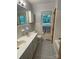 This bathroom boasts double sinks, patterned floors, and a window for ample natural light at 103 Boyd Dr, Stanley, NC 28164